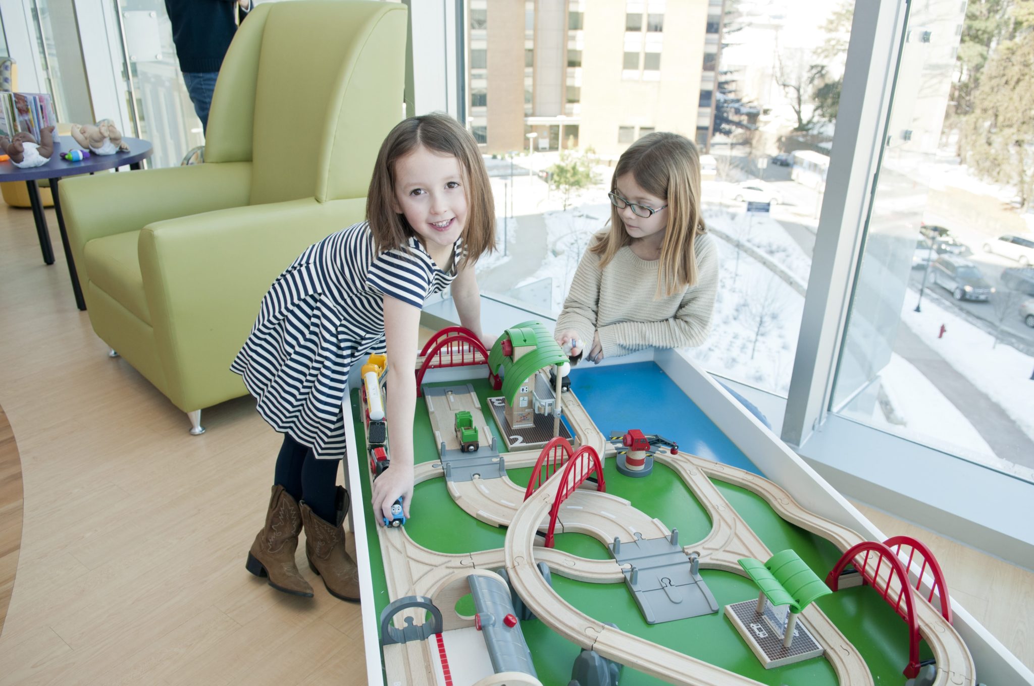 Two girls play with wood cars in UVA's child radiology office