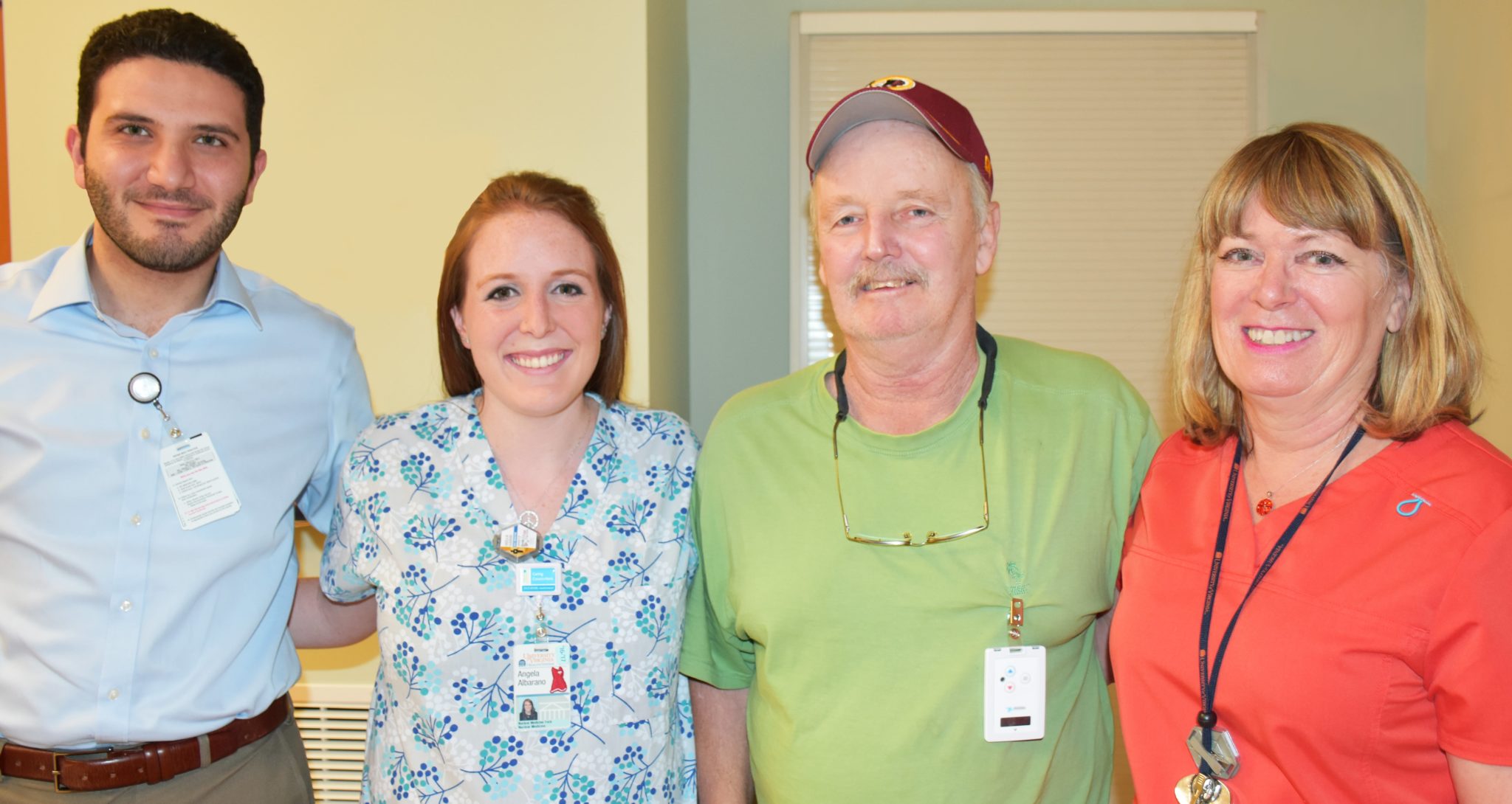 UVA radiation treatment patient and staff stand smiling at the camera