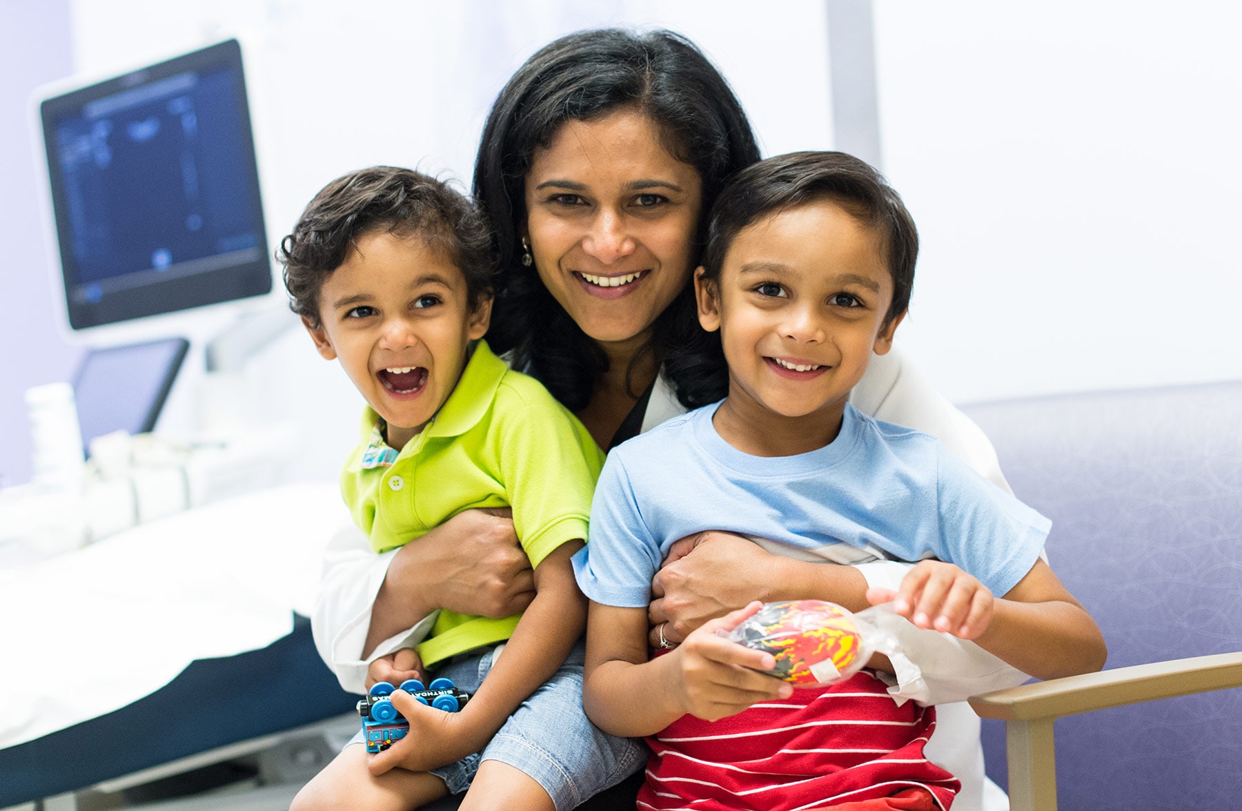 A mom with her two kids in the pediatric radiologist office