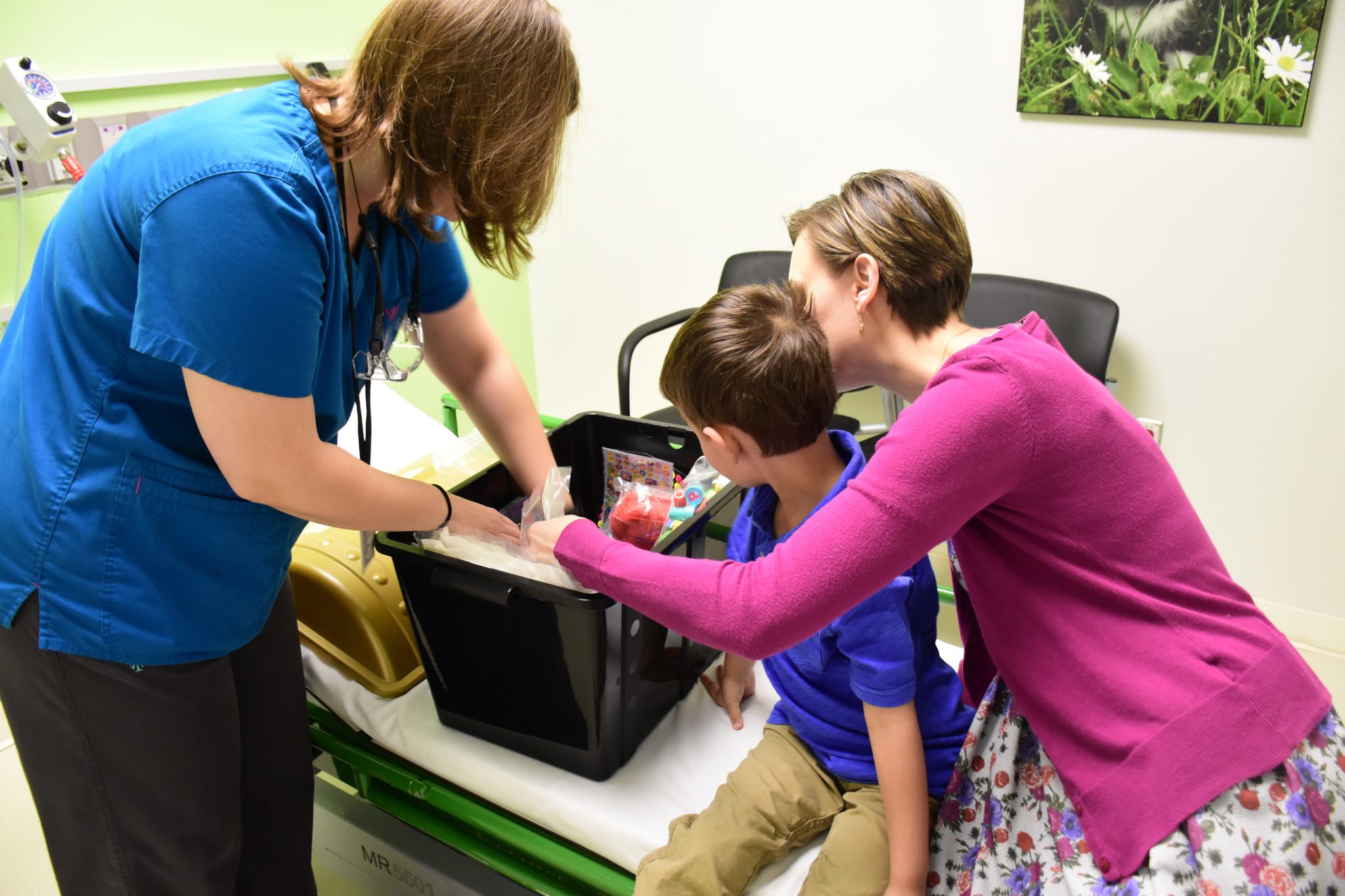 A boy goes through the treasure chest with his mother after an MRI exam