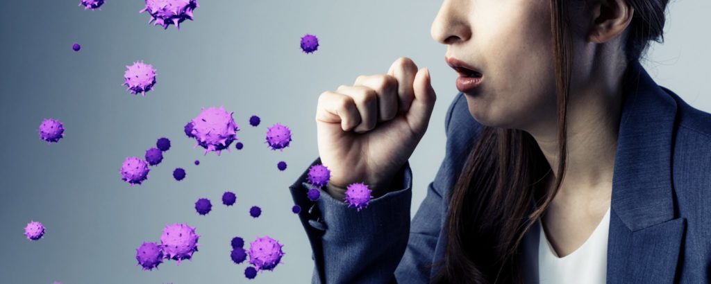 a woman coughs into her hand while graphics show the spread of a virus from coughing